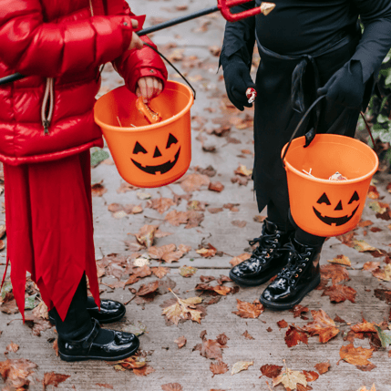 Children dressed in Halloween costumes, showcasing long sleeves and pants to protect against ticks and mosquitoes